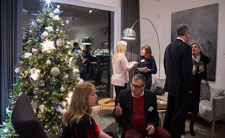 View of the lounge area during the Holiday Party with our Christmas tree and guests chatting in a calm and relaxed atmosphere.